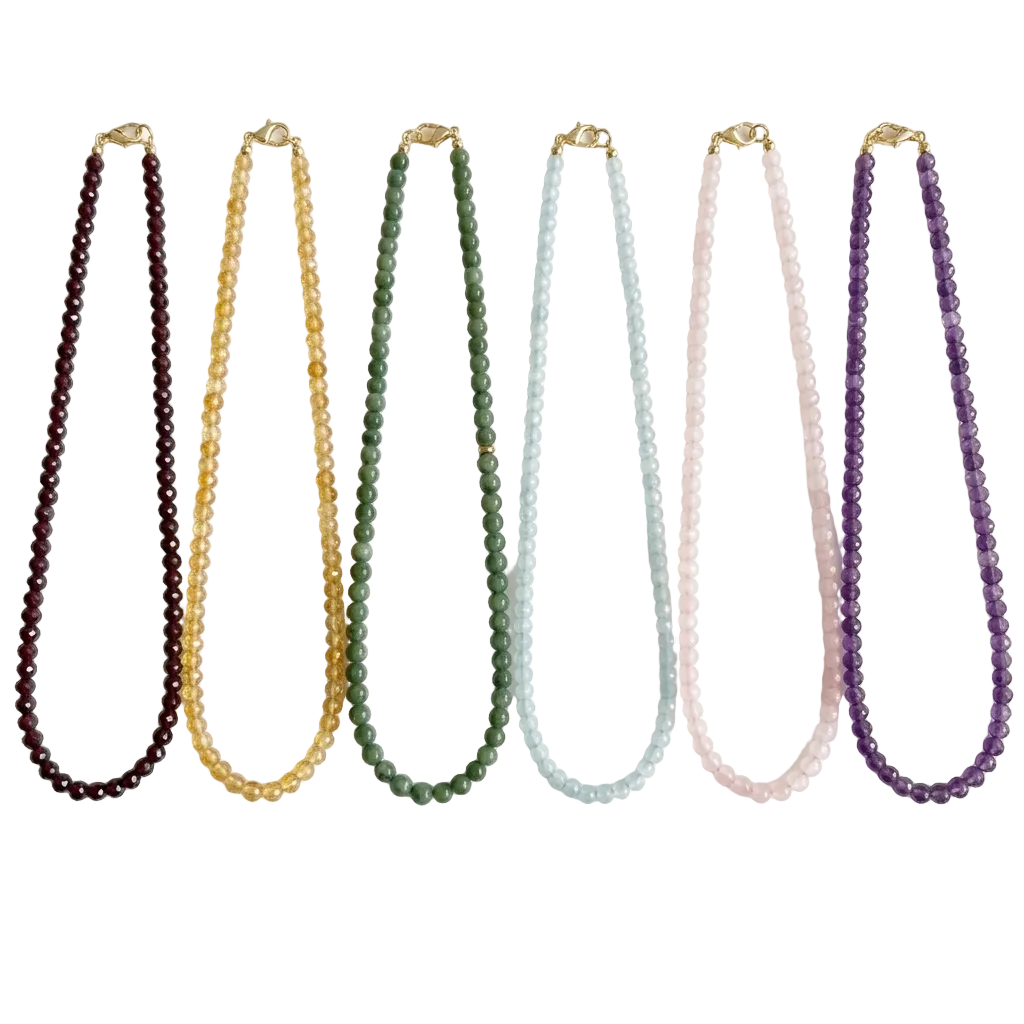 Set of six beaded necklaces in various colors on a white background