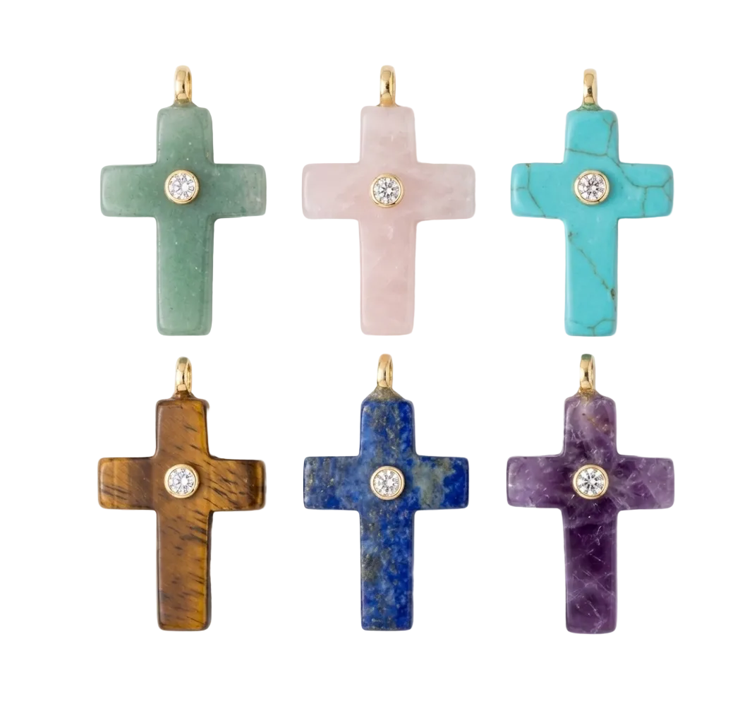 Set of colorful cross-shaped jewelry pieces on a white background