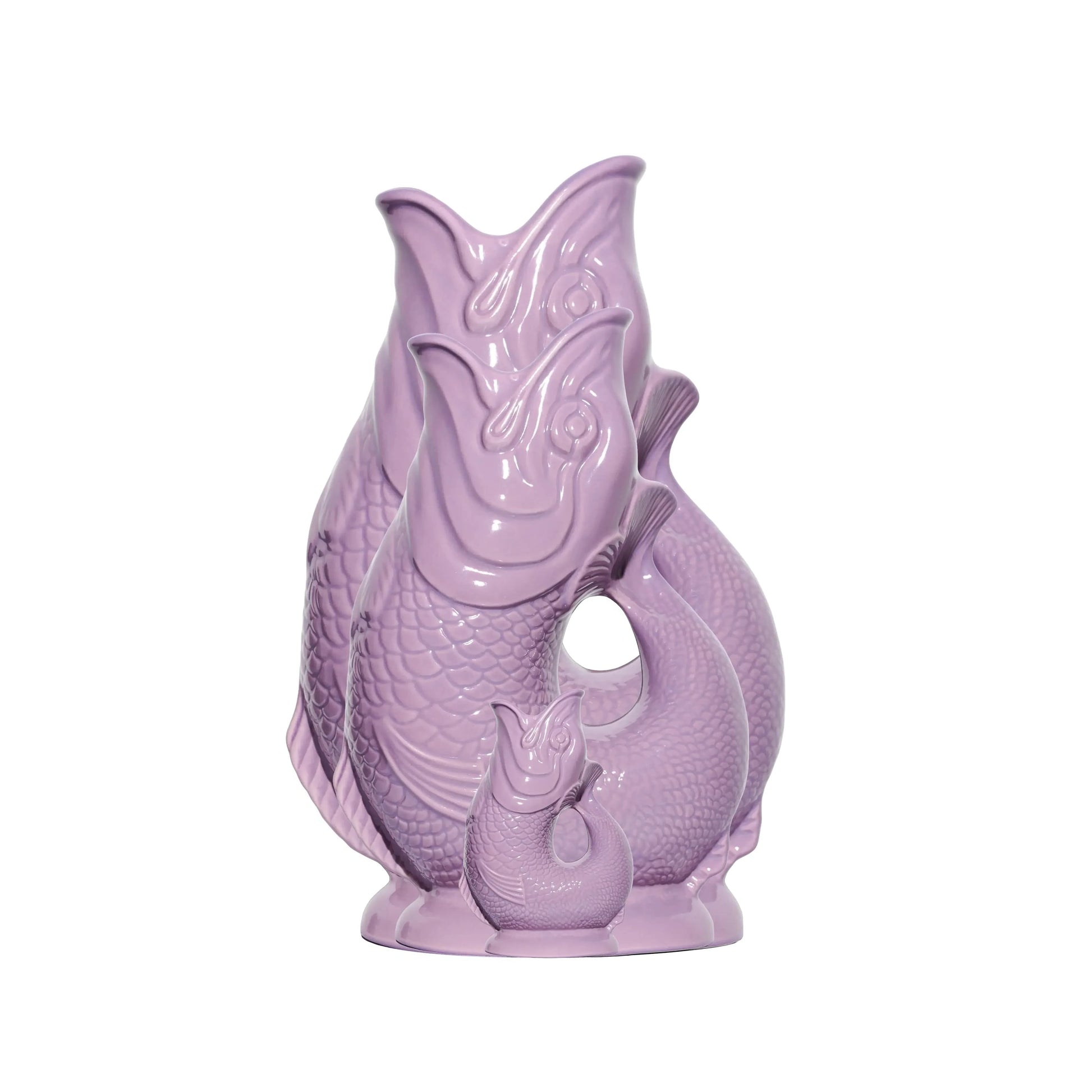 Purple ceramic fish-shaped object on a white background
