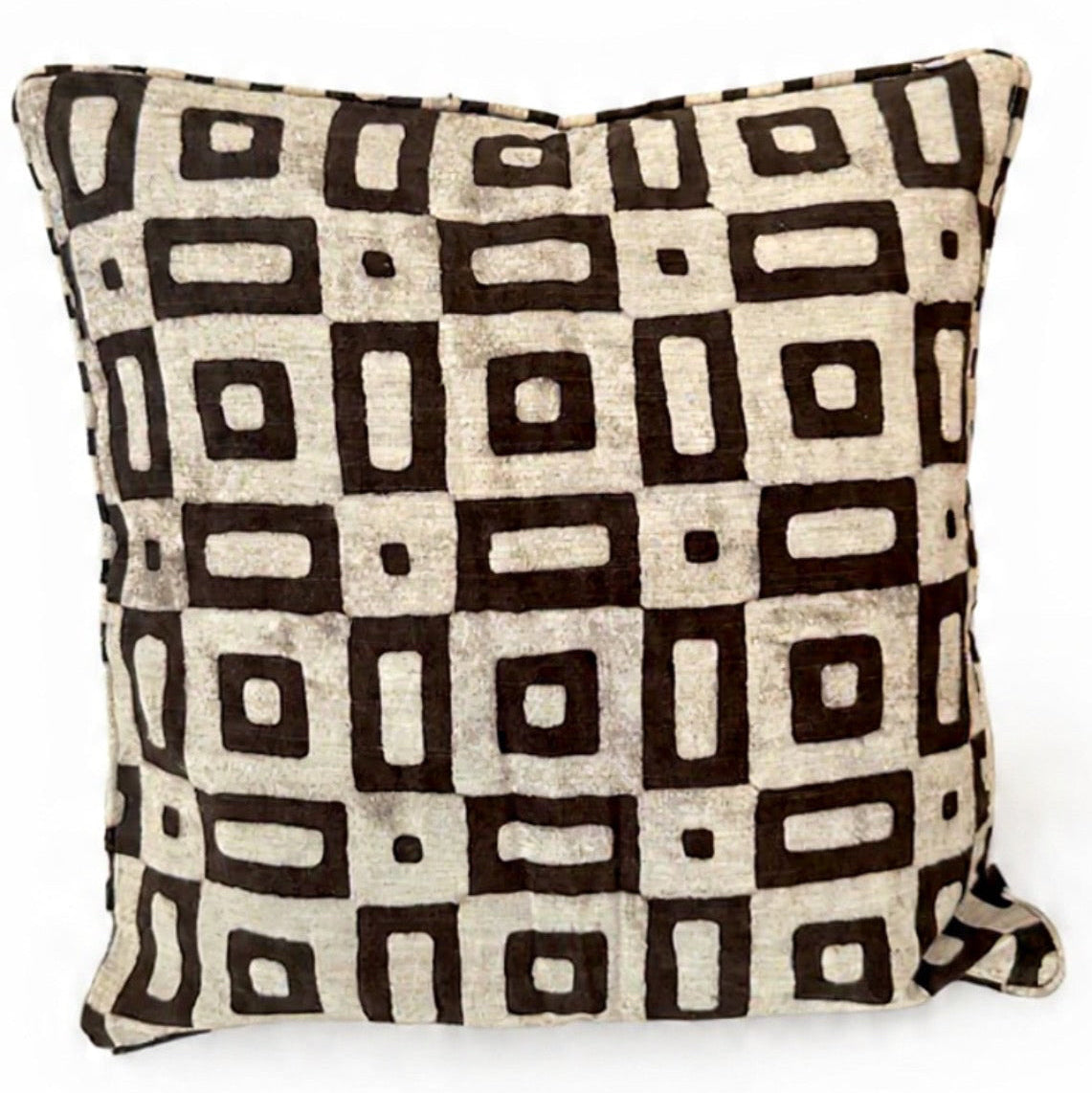 Decorative pillow with black geometric pattern on beige background