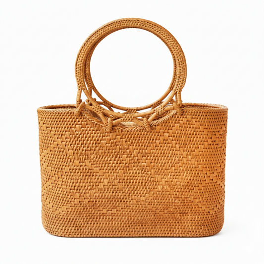 Brown woven handbag with circular handles on a white background