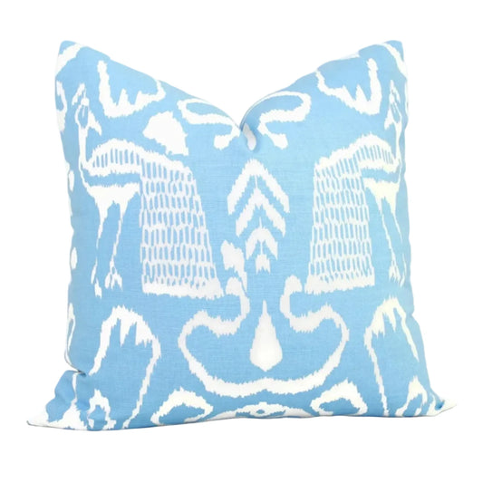 Decorative pillow with white abstract pattern on a light blue background