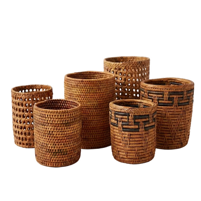 Set of wicker woven cups  in various sizes on a white background