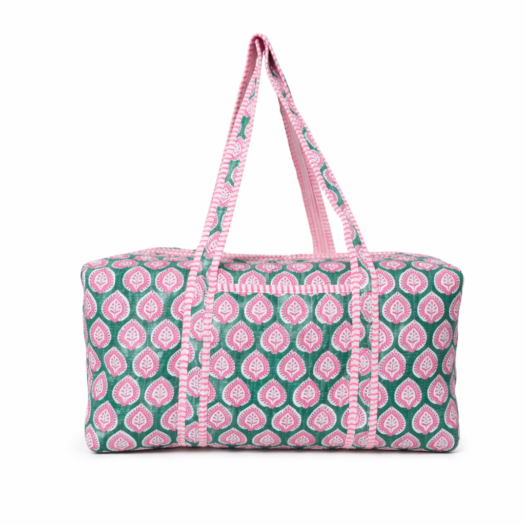 Patterned duffel bag with pink and green design on a white background