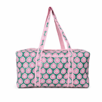 Patterned duffel bag with pink and green design on a white background