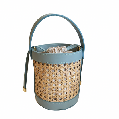 Woven basket with a blue handle on a white background