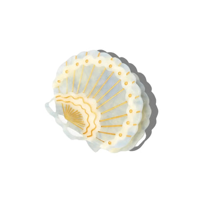 Shell-shaped hair clip with gold accents on a white background