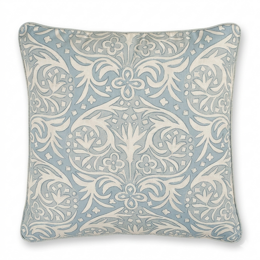 Decorative pillow with a light blue and white floral pattern on a white background