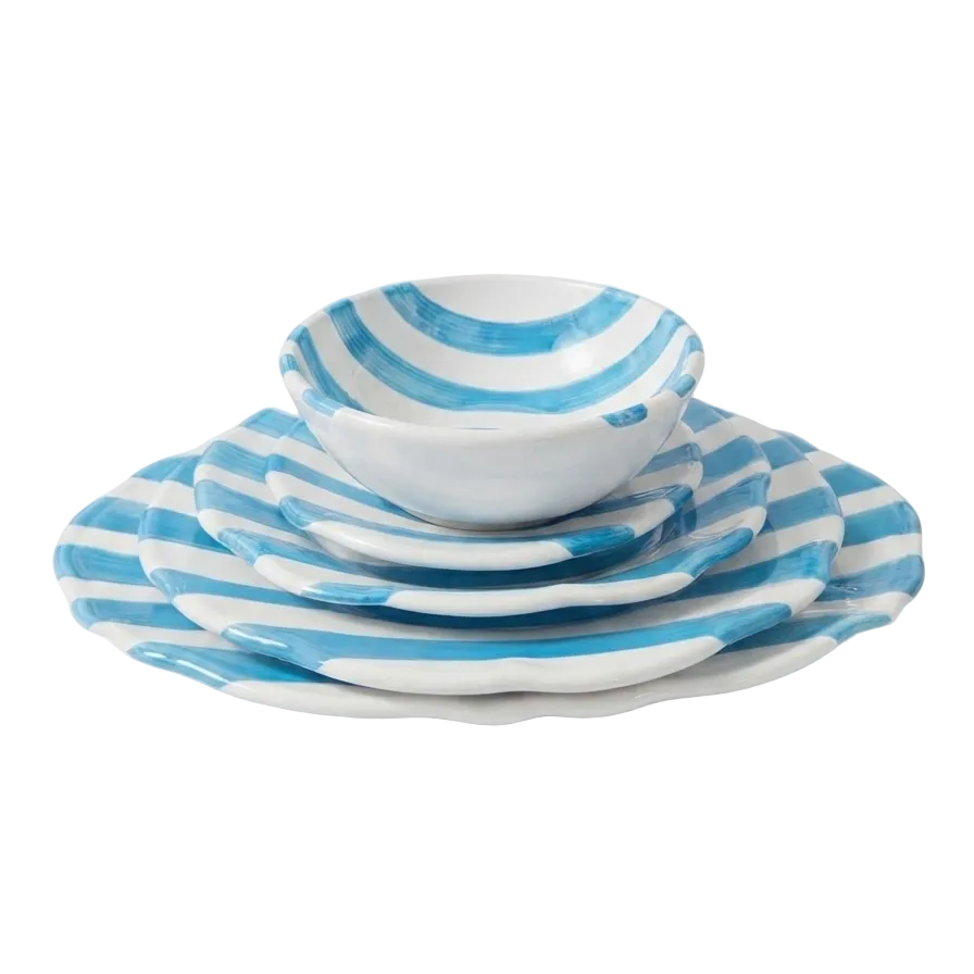 A set of white ceramic dinnerware with light blue stripes, including a stack of plates and a small bowl, photographed on a clean white background.