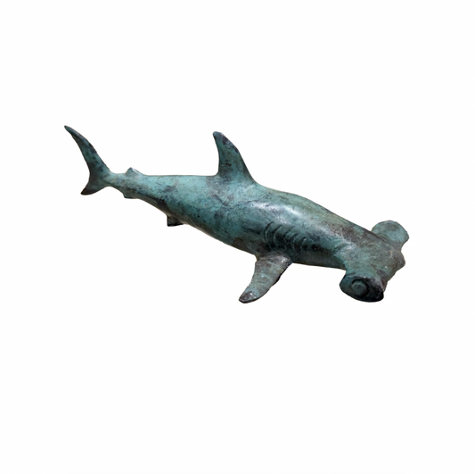Bronze hammerhead shark sculpture on a white background