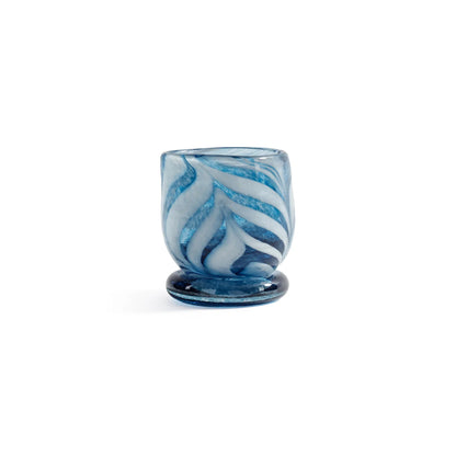 Blue and white marbled glass cup on a white background