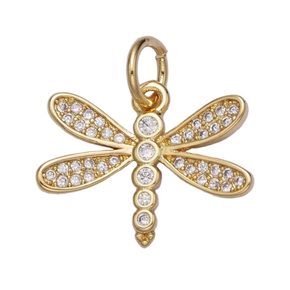 Gold dragonfly pendant with clear gemstones on a white background