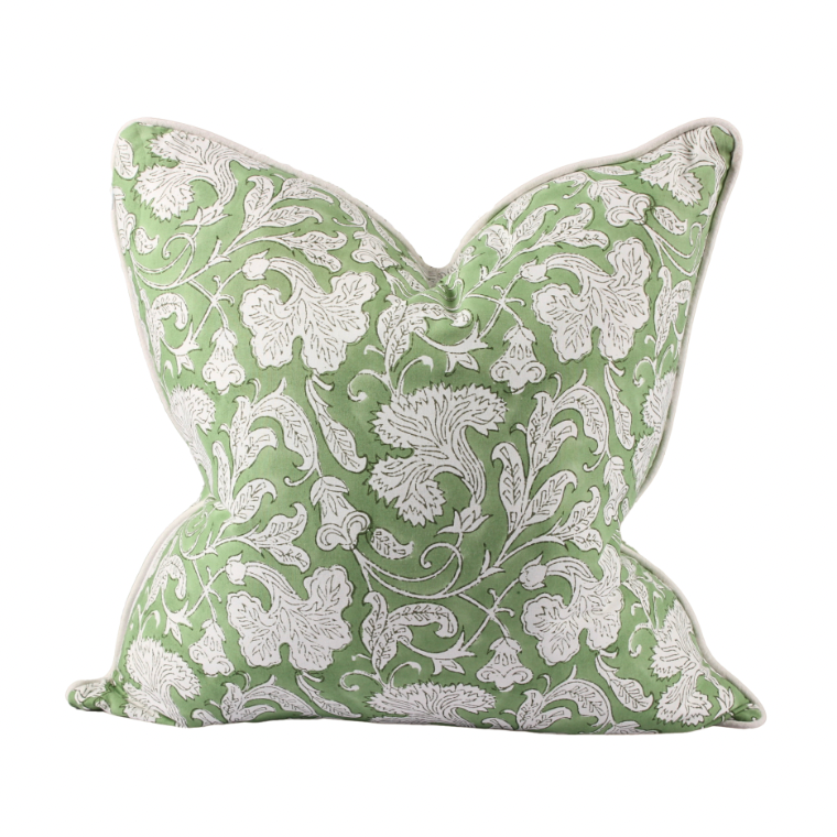 Green pillow with white floral pattern on a white background