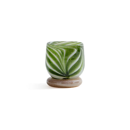 Green and white marbled ceramic candle holder on a white background
