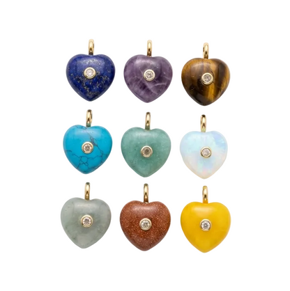 Set of heart-shaped stone pendants in various colors on a white background