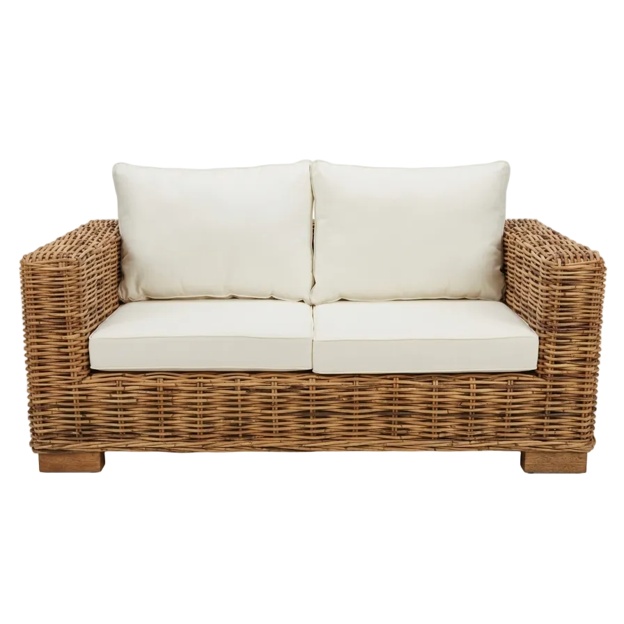 Wicker loveseat with white cushions on a white background