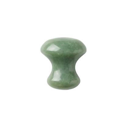 Green stone tool on a white background