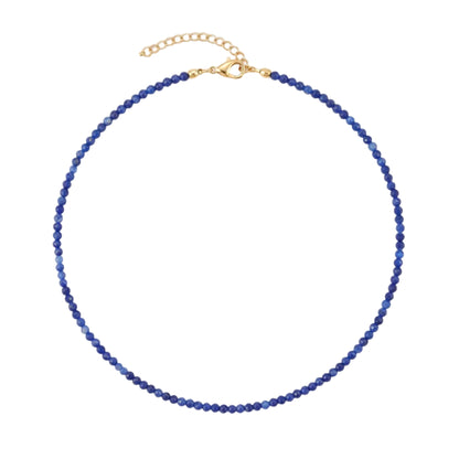 A beaded necklace made of small faceted blue beads with a gold-tone clasp and extender chain, photographed on a plain white background.