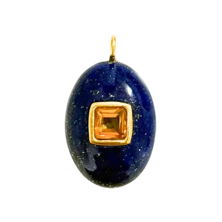 Blue stone pendant with a gold frame and yellow gemstone on a white background