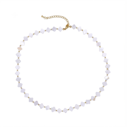 A delicate choker necklace featuring small, faceted white beads set in gold-tone metal, with a gold-tone extender chain at the clasp, displayed on a solid white background.
