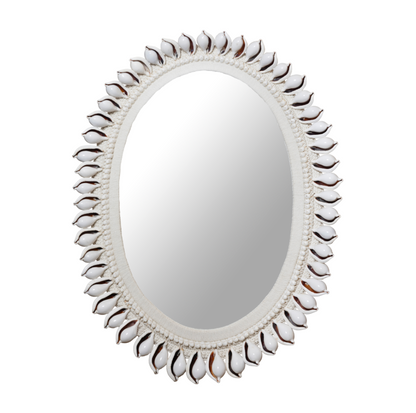 Decorative mirror with a shell-like frame on a white background