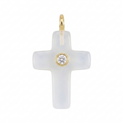 White cross pendant with gold accents on a white background