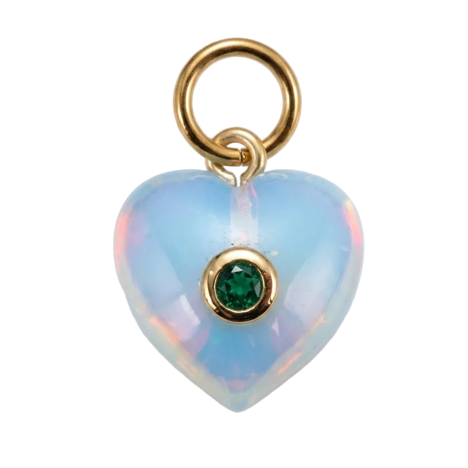 A heart-shaped opal pendant charm with a gold ring loop at the top and a small round green gemstone in the center, set against a plain white background.