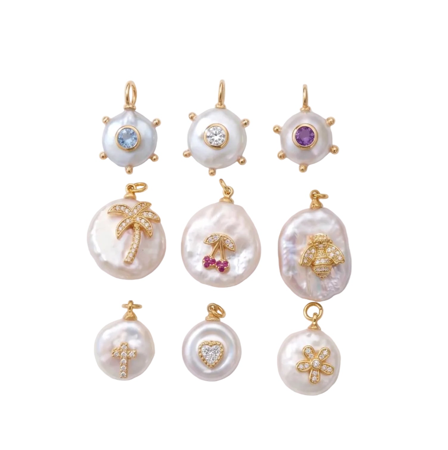 Nine gold and pearl pendants arranged in a 3x3 grid on a white background with soft diagonal shadows. The pendants feature various motifs including a palm tree, cherry, cross, flower, sun, and abstract shapes, embellished with small colored gemstones.