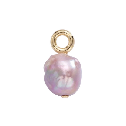 Pearl charm with gold setting on a light purple background