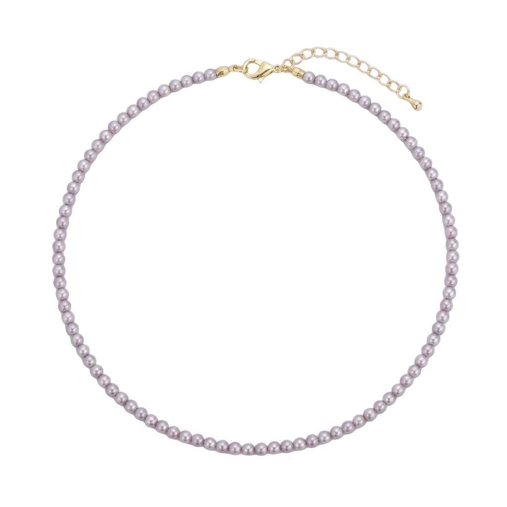 A delicate pearl necklace with small, round, light pinkish-beige pearls and gold-tone hardware, including a lobster clasp and extension chain, displayed on a clean white background.