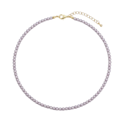 A delicate pearl necklace with small, round, light pinkish-beige pearls and gold-tone hardware, including a lobster clasp and extension chain, displayed on a clean white background.