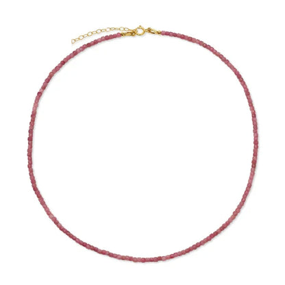 Necklace with pink beads and gold clasp on a white background