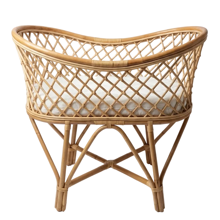 Wicker baby crib with white mattress on a plain background