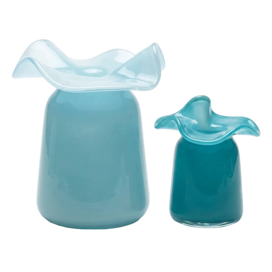 Two glossy glass vessels in shades of light and dark blue, featuring tapered bodies and wavy, flared rims, photographed on a clean white background.
