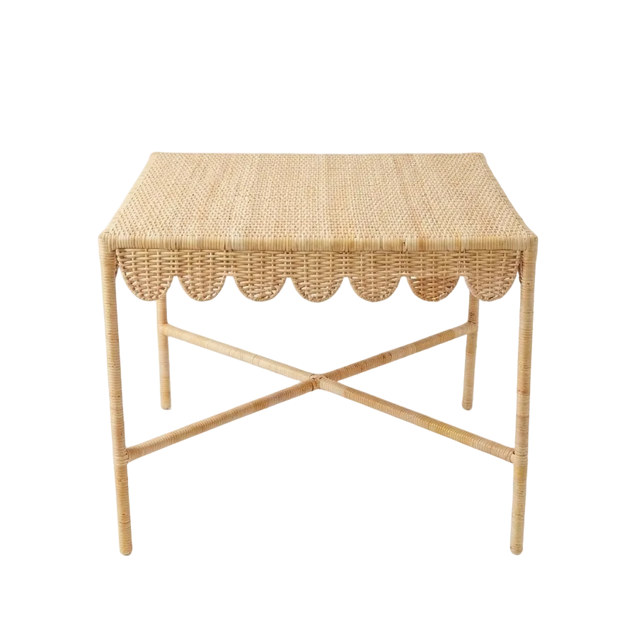 Woven side table with scalloped edge on a white background