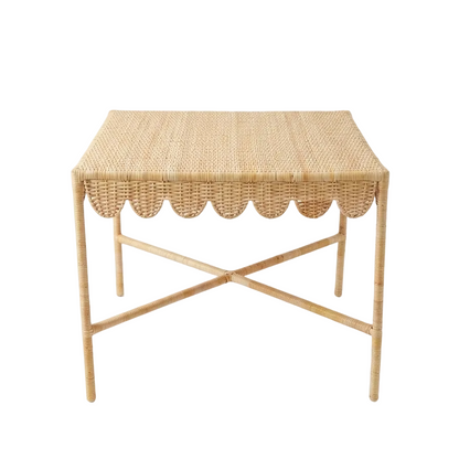 Woven side table with scalloped edge on a white background
