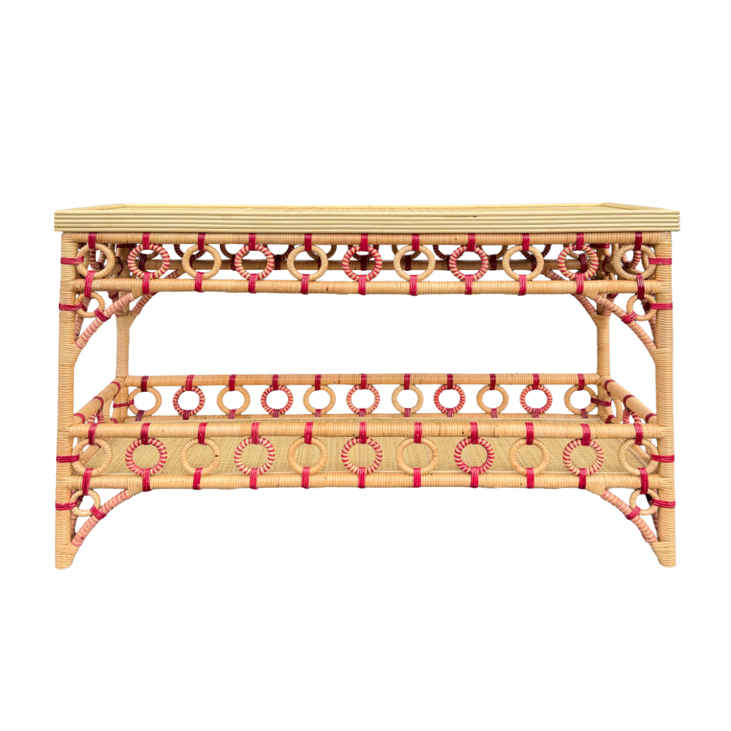 Wicker console table with decorative red accents on a white background