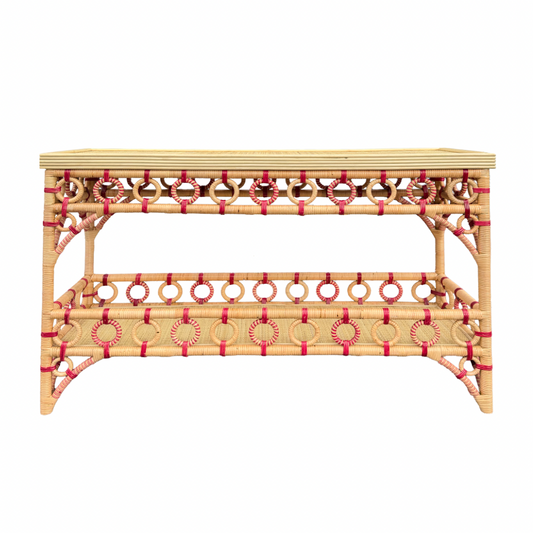 Wicker console table with decorative red accents on a white background