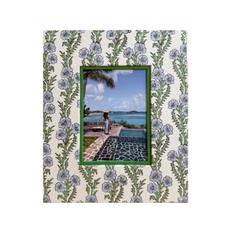 Decorative photo frame with floral pattern and scenic view inset