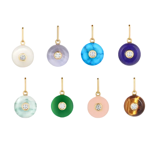 Set of colorful gemstone charms with gold on a white background