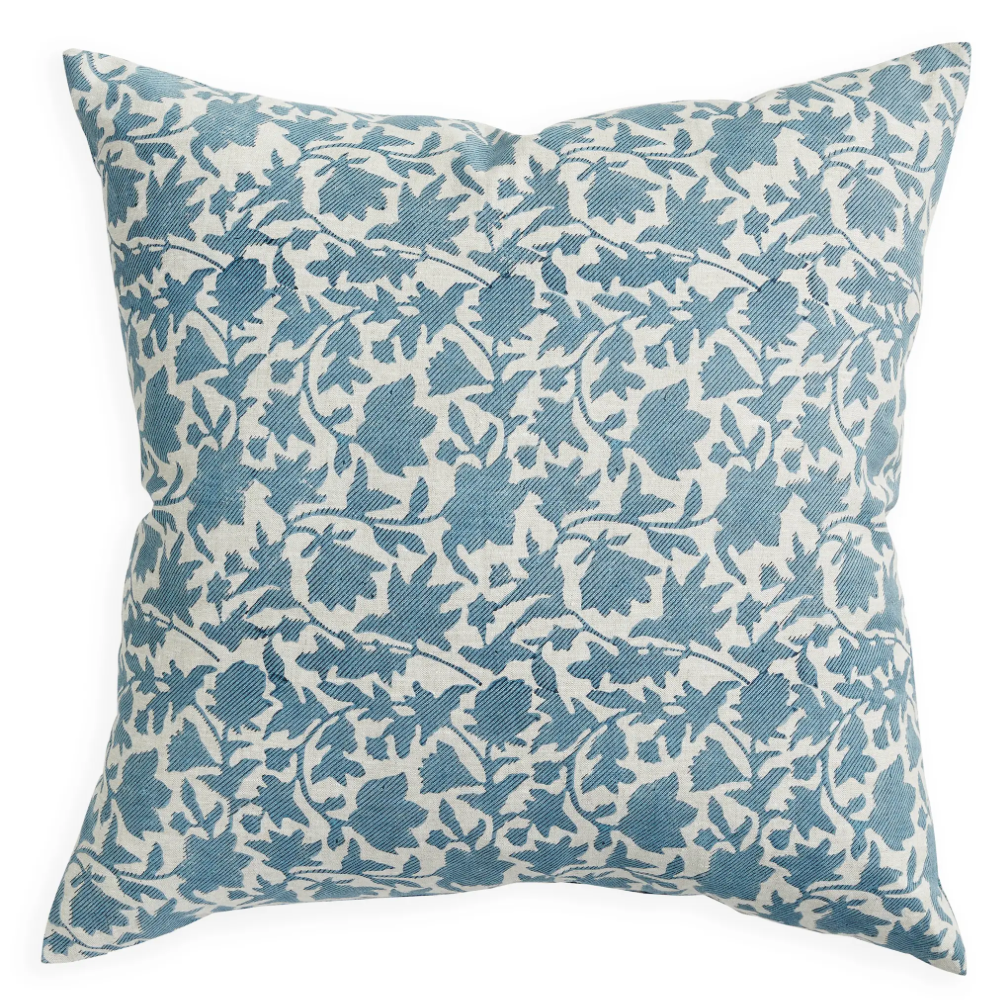 A square throw pillow featuring a blue floral vine pattern printed on a cream-colored fabric background, shown against a plain white studio background.