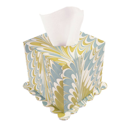Marbled patterned tissue box cover with tissues on a white background