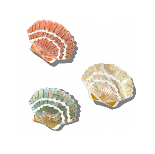 Three seashell haircuts of different colors on a white background
