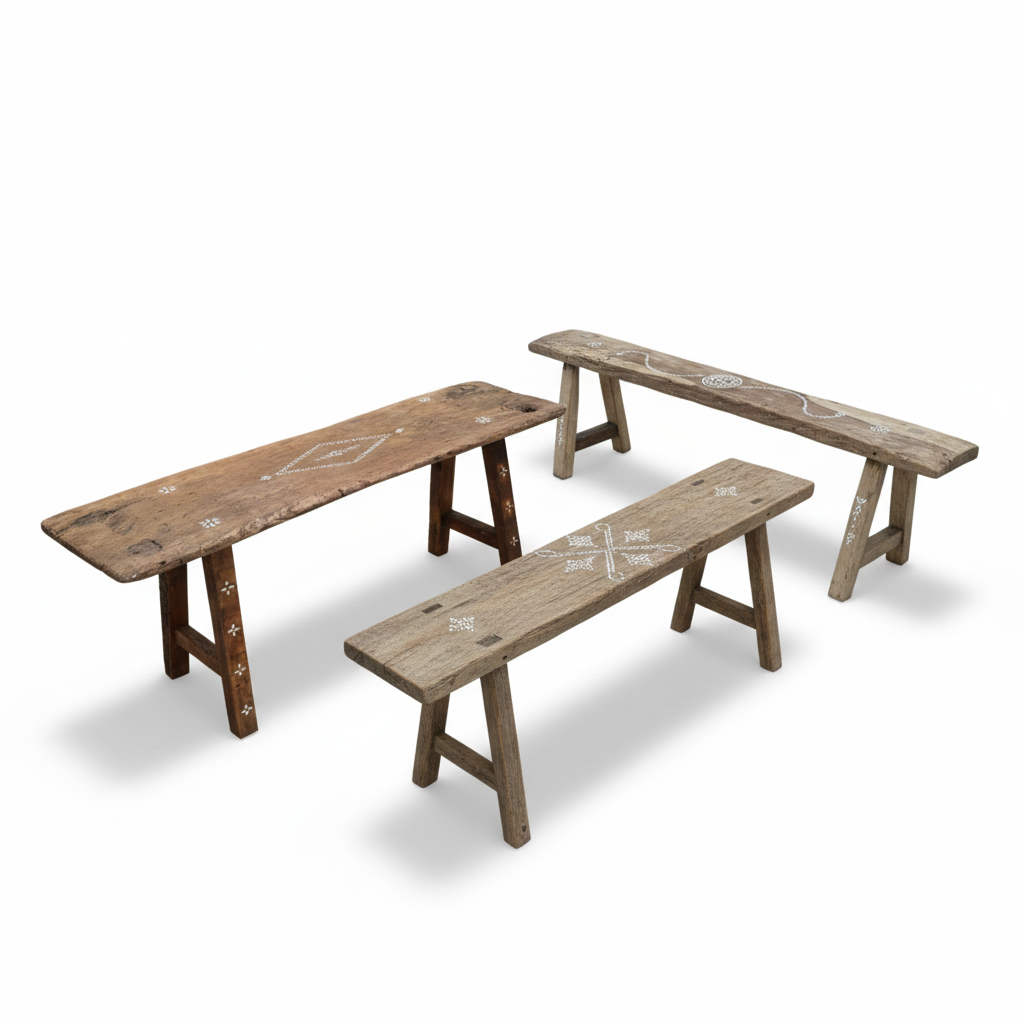 Three wooden benches with engraved designs on a white background