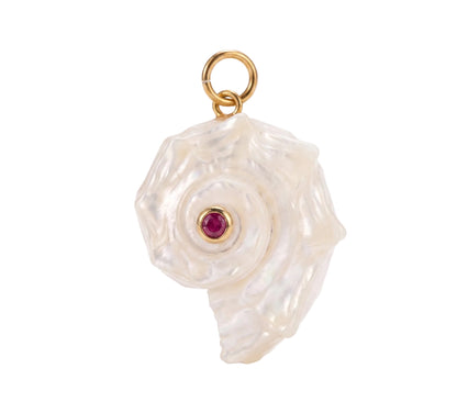A sculptural pendant featuring a textured, organic white shell-like form with a small round red gemstone at its center and a gold-tone ring at the top, shown on a clean white background.