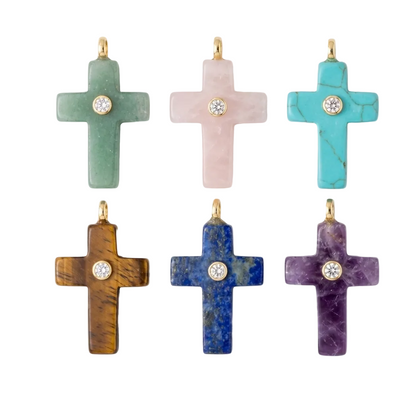Set of colorful cross-shaped jewelry pieces on a white background