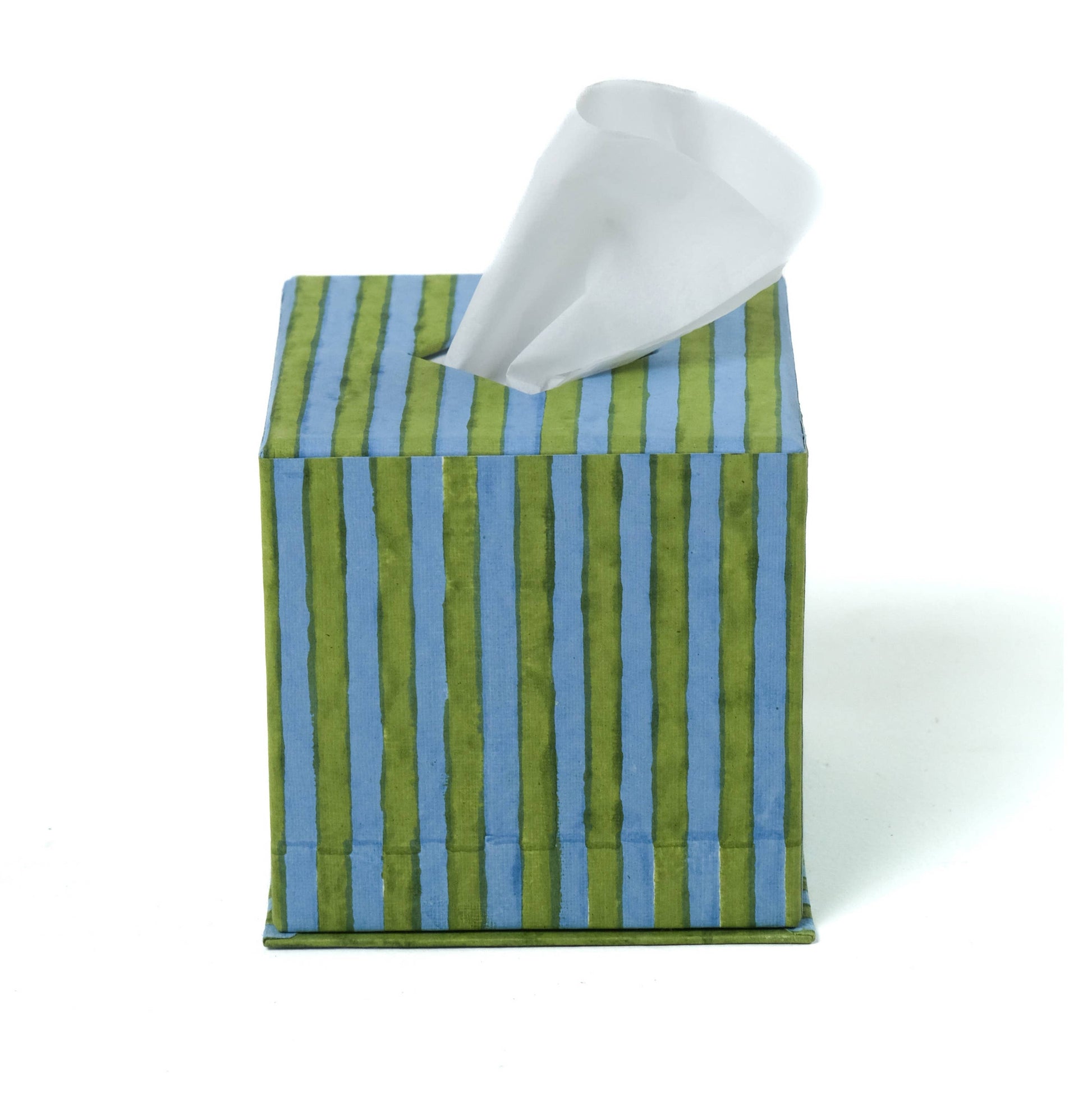 Striped tissue box cover with a tissue peeking out on a white background