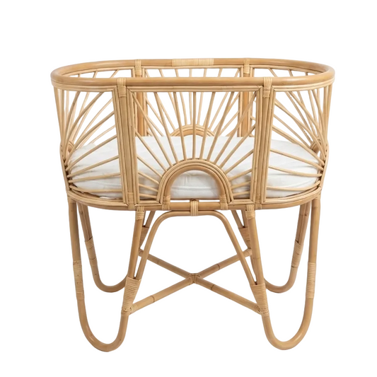 Wicker baby crib on a white background