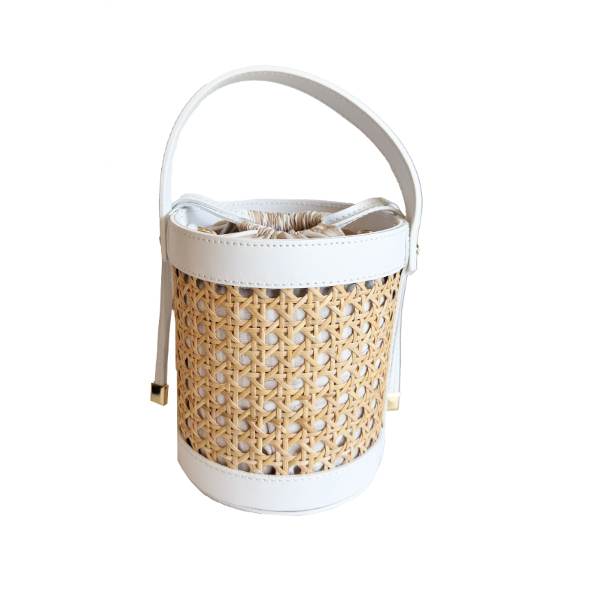 Woven basket with a white handle on a white background