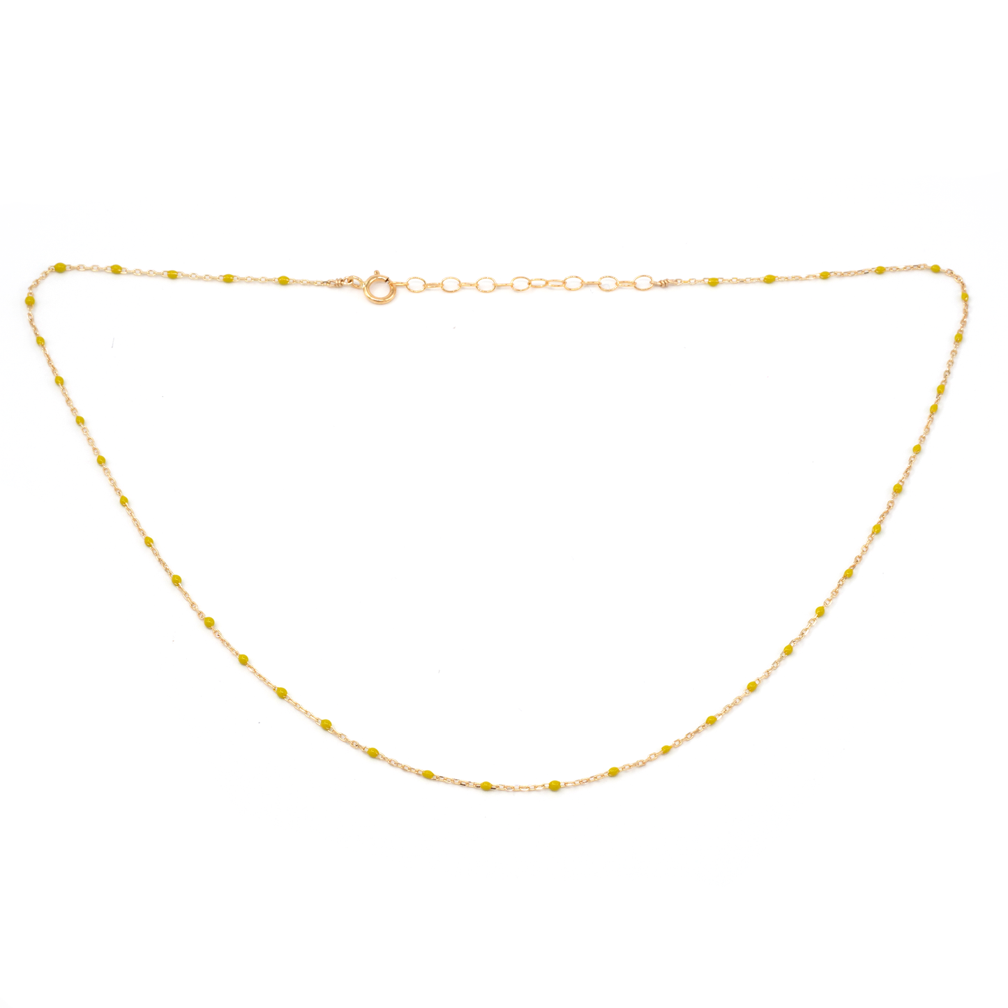 Gold necklace with small yellow beads on a white background